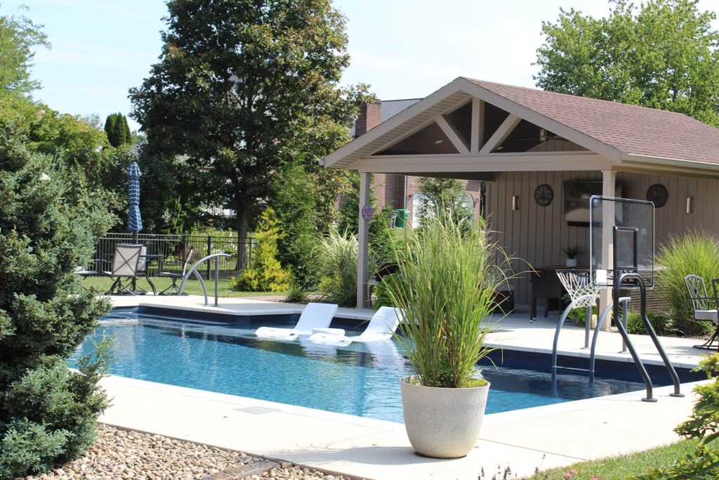 Lanscaping surrounds an inground pool.